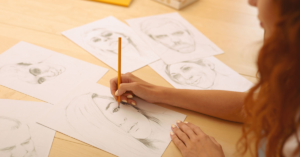 photo shows a person drawing a face