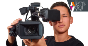 photo shows a young person holding a video camera
