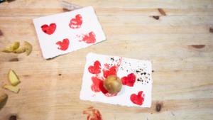 image shows prints of heart shapes on white paper