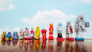image shows colourful robotic toys in a row on wooden floor